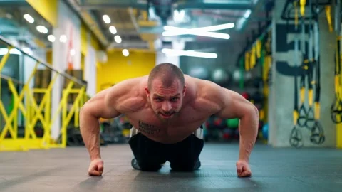 Bald bodybuilder exercising in the gym. Raises the barbell, dumbbells. Stock Footage 238777789