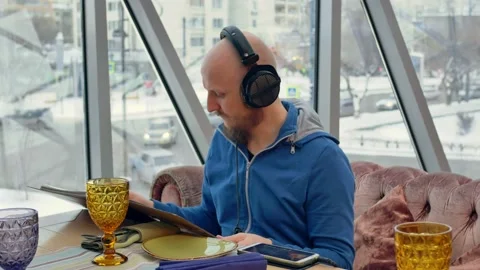 A bald brutal man with a beard and a short-cropped mustache spends his free time Stock Footage 153644085
