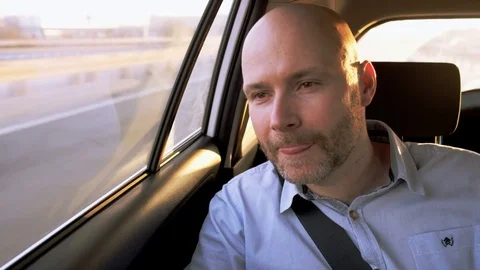 Bald Businessman in the Car Looking Through a Window Stock Footage 74654403