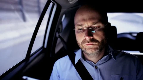 Bald Businessman in the Car Putting a Headphone On Stock Footage