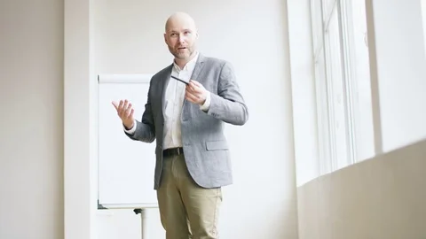 Bald Businessman Claryfying Something During a Lecture Stock Footage 73119009