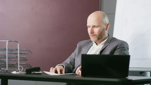 Bald Businessman Comparing Carefully Two Documents Stock Footage 73125105