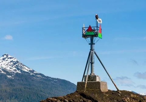 A Bald Eagle perched on top of a navigation marker near Ketchikan, Alaska Stock Photos