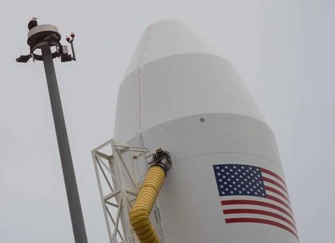 A bald eagle is seen atop a lightning tower next to the Northrop Grumman A... Stock Photos