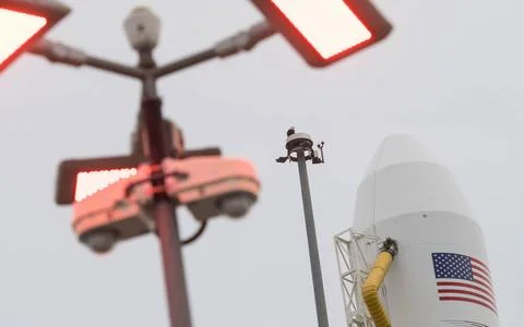 A bald eagle is seen atop a lightning tower next to the Northrop Grumman A... Stock Photos
