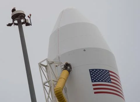 A bald eagle is seen atop a lightning tower next to the Northrop Grumman An.. Stock Photos