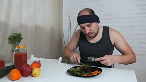 A bald fat vegetarian disgustingly eats salad. Proper nutrition, healthy 스톡 동영상 119074365