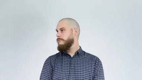 The bald guy with the bushy beard turns his head showing his hair style Stock Footage 122012428