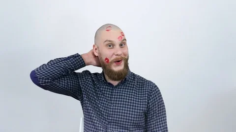 The bald guy with lipstick traces on my face is confused. Stock Footage 122012459