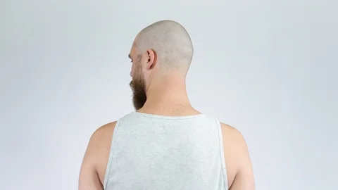 The bald guy standing with his back to the camera.Short haircut and beard Stock Footage 122005437