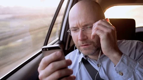 Bald Man Adjusting Glasses and Dialing a Phone Number Stock Footage 74648583