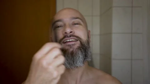 Bald man with a beard. beard styling in the bathroom Stock Footage 230165729