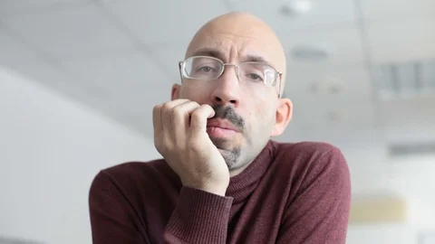 A bald man with a beard, emotionally talking with someone Stock-Footage 129708091