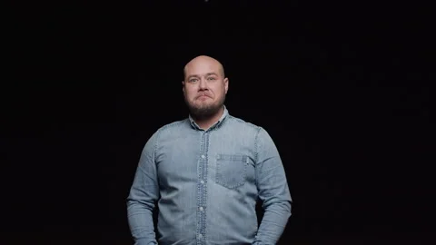 A bald man with a beard makes a surprised face and shakes his head affirmatively Stock Footage 195985187