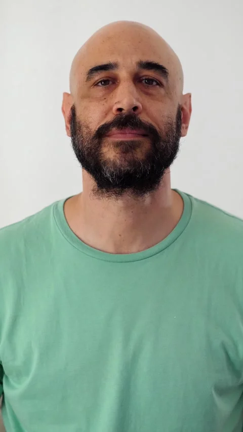 Bald man with beard proudly looking at the camera Stock Footage 295141869