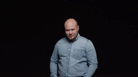 A bald man with a beard raises his head and looks in front. Stock Footage 195985954