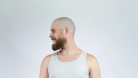 The bald man with the beard turns and looks in the camera fun. Stock Footage 121975397
