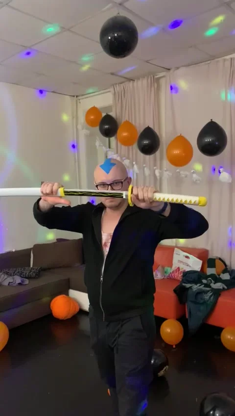 Bald man with blue arrow on head is pulling sword out of its sheath. Stock Footage 236168479
