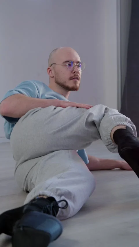 A bald man in a dance studio is dancing and teaching an erotic dance during a Stock Footage 305506814