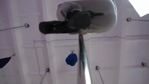 Bald man is doing pole dance, he rotates on a pole for striptease Stock Footage 305324012