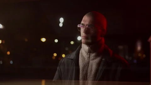 Bald Man with glasses standing outside and looking through the window Vidéo 258535283