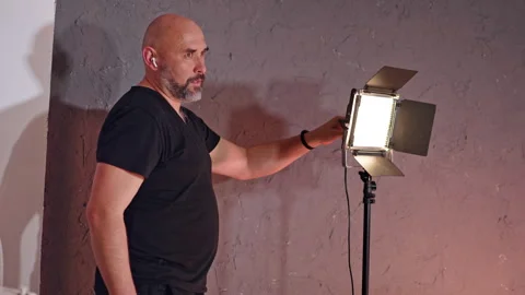 Bald man with grey beard stands near the soffit. Vídeo Stock 308015268