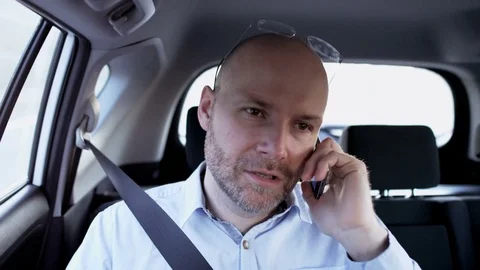 Bald Man Looking Ahead While Talking on the Phone Stock Footage 74771309