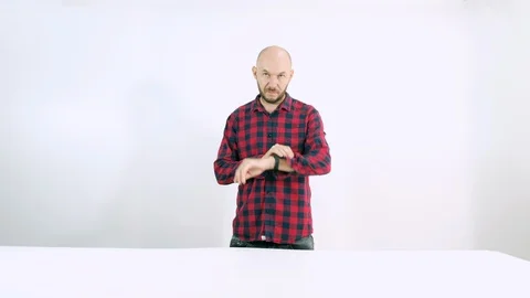 Bald man looking time on white background Stock Footage 102788730