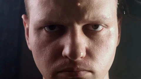 A bald man looks into the camera while he is being cut bald with a clipper Stock Footage 170723948