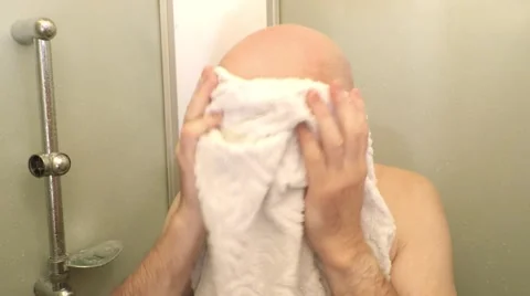 Bald man massaging his head with towel. Video stock 58752520