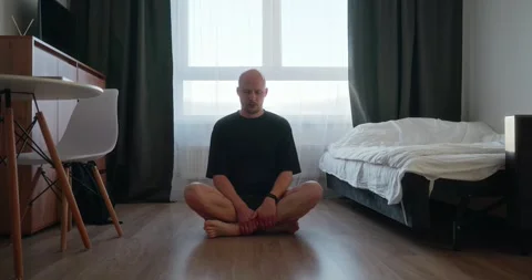 A bald man millennial freelancer took a break from work and does yoga Video stock 302901285