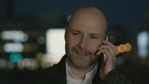 Bald Man Moving to the Left and Right During a Phone Call Stock Footage