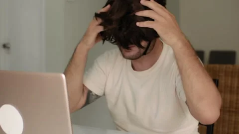 A bald man playfully puts on a wig and talks on a videocall Vídeos de archivo 145746444