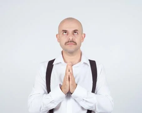 Bald man praying,imploring, hands clasped hoping of miracle Stock Photos