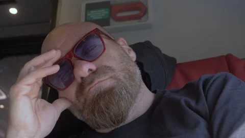 Bald man with red goatee reflecting during train journey Stock Footage 334775704