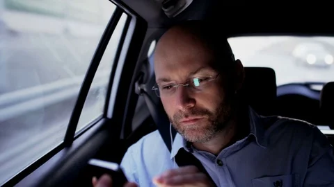 Bald Man Sitting in the Car and Adjusting His Glasses Stock Footage 77573656