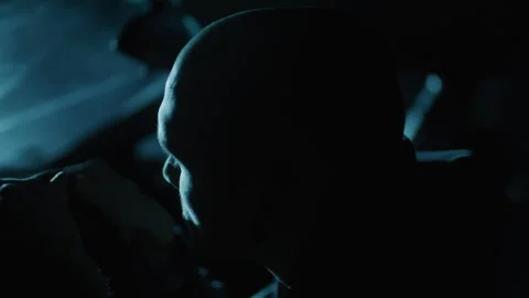 Bald Man with Sitting in the Car in the Dark and waiting Vidéo 258441833