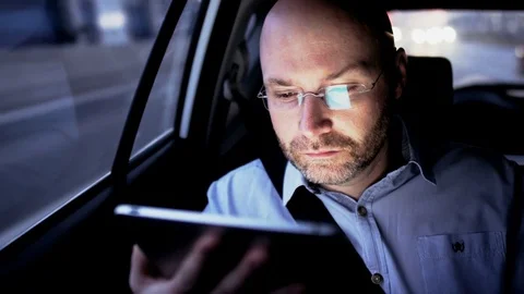 Bald Man Using a Tablet and Looking Through the Window Stock Footage