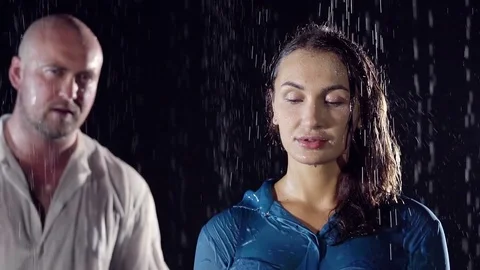 Bald man in a white wet shirt fit from the back for his beloved wife. they stand Stock Footage