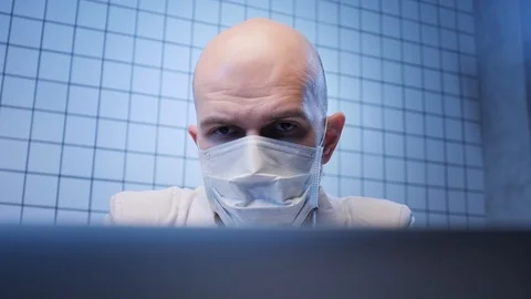 Bald man works on computer in coronavirus researching lab Video stock 124892689