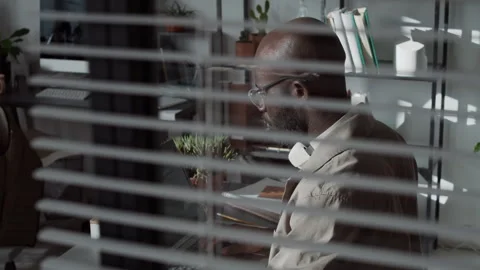 Bald Programmer with Glasses Writing Code on Laptop during Workday Stock Footage 299205436