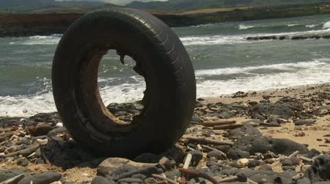 Bald tire on the beach Stock Footage 8848826