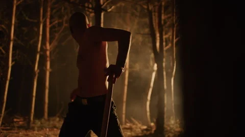 Bald young Man Digging a Grave in the forest Stock Footage 259079162