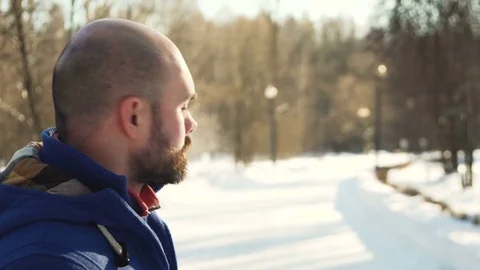 Bald young man portrait in winter park Stock Footage 72279070