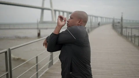 Bald young man warming up before training. Stock Footage 100351191