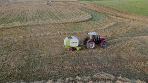 Baler wrapper working on the  field.  Stock Footage 204927029
