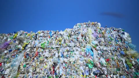 Bales of  PLASTIC WASTE left in the sun Stock Footage 263611907
