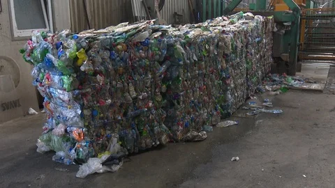 Bales of waste plastic bottles ready for recycling. Compressed plastic. Stock Footage 122000308