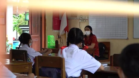 Bali, 5 Jan 2023: Students in school uniforms seen through classroom window.. Stock Footage 310476770