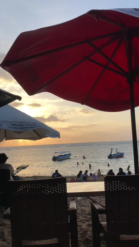 Bali Beach Sunset With Red Umbrella Silhouette and Traditional Boats Видео 334763199